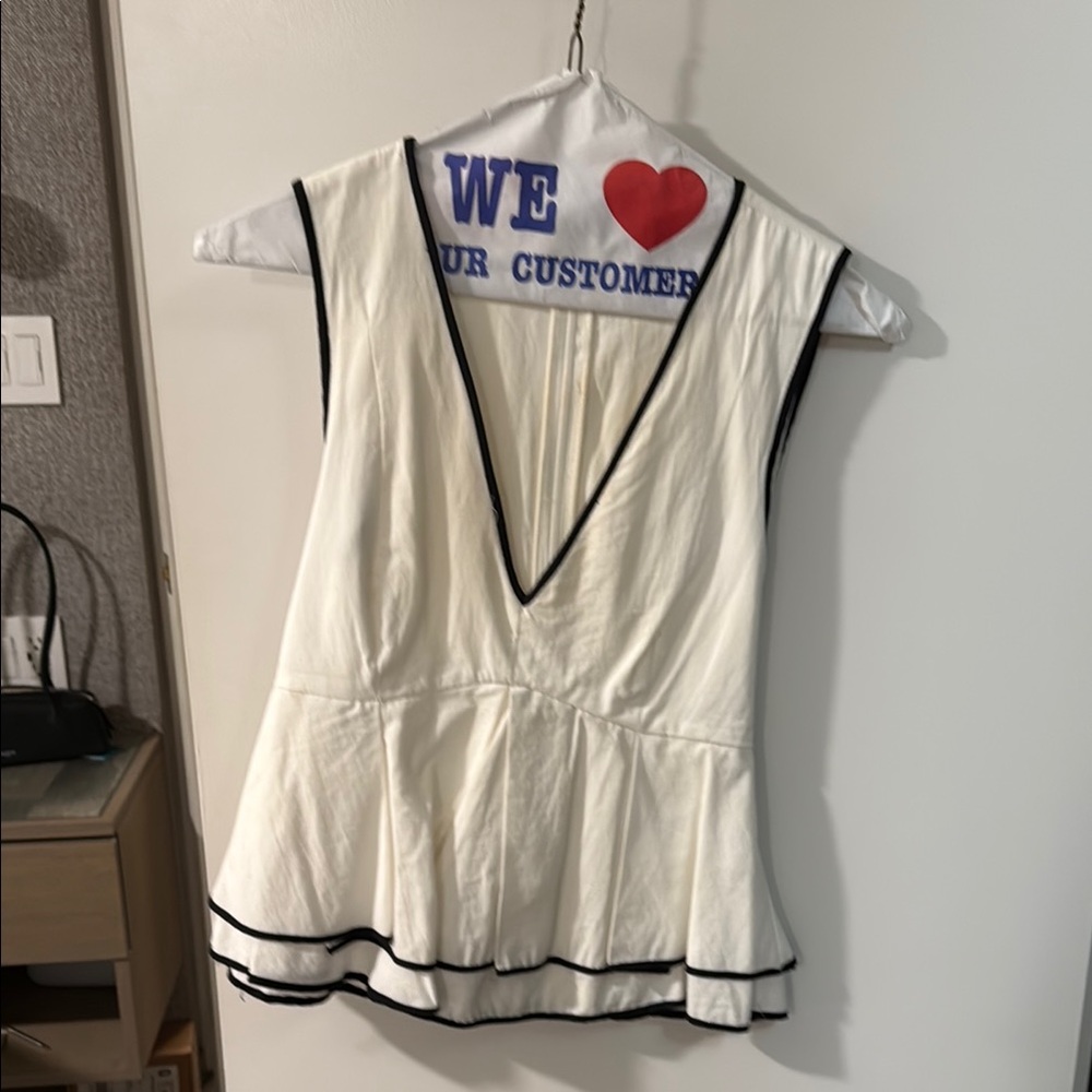 Sleeveless White Top with Black Trim